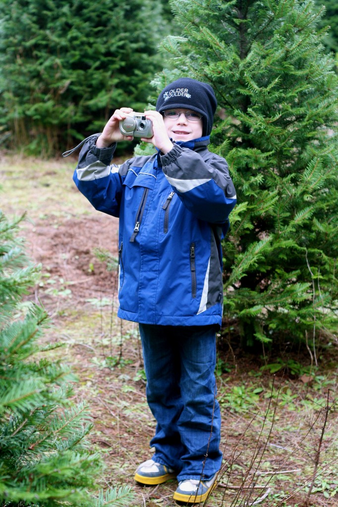 The budding artist is enjoying practicing his craft amongst the trees...